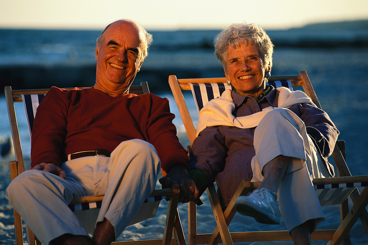 Happy Older Couple in Beach Chairs