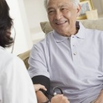 Cheerful Senior Man Having His Blood Pressure Taken