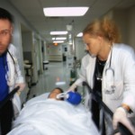 Doctors Rushing Patient down Hall